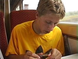 Ryan sharpens a straw with his penknife on the train from Carlisle to Newton Abbot